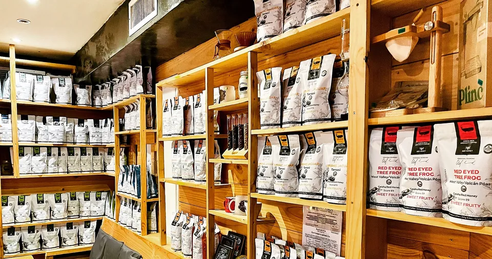 Wall of Nordico Costa Rican specialty coffee bags at the flagship store in Tamarindo