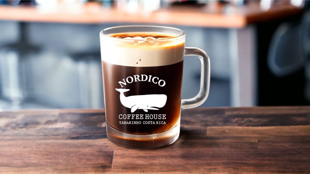 A nitrogen cold brew coffee on a bar counter in a Nordico cup